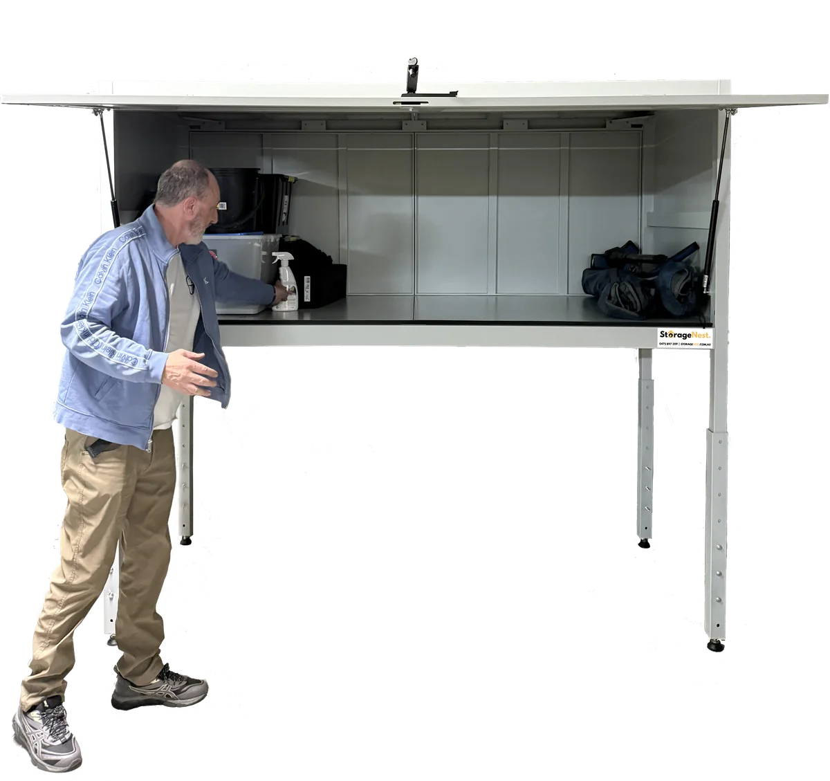 A man loading gear into the open Kookaburra storage unit